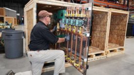 01 PM 1223 FW Webb feature: F.W. Webb Boiler Board Technician Jeff Hutchins prepares preassembled hydronic panels for shipment.