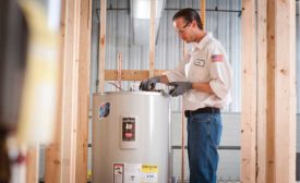 Josh Burk pipes a water heater in one of the school’s wet training modules