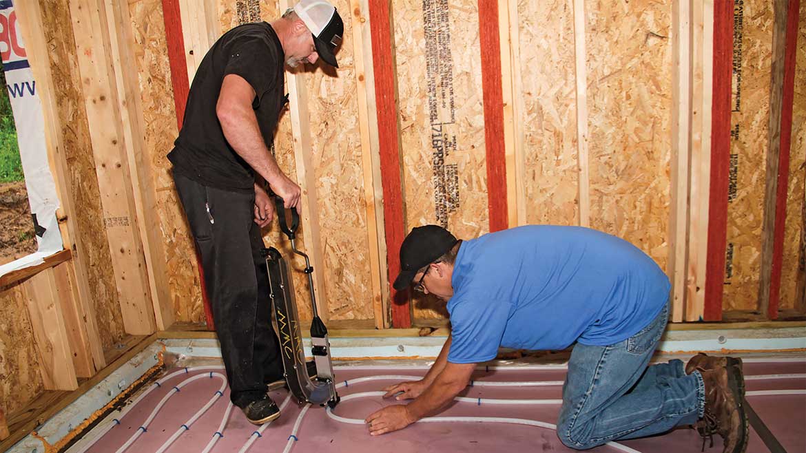 Uponor Johnson Residence in Afton MN. Contractors installing floor heating.